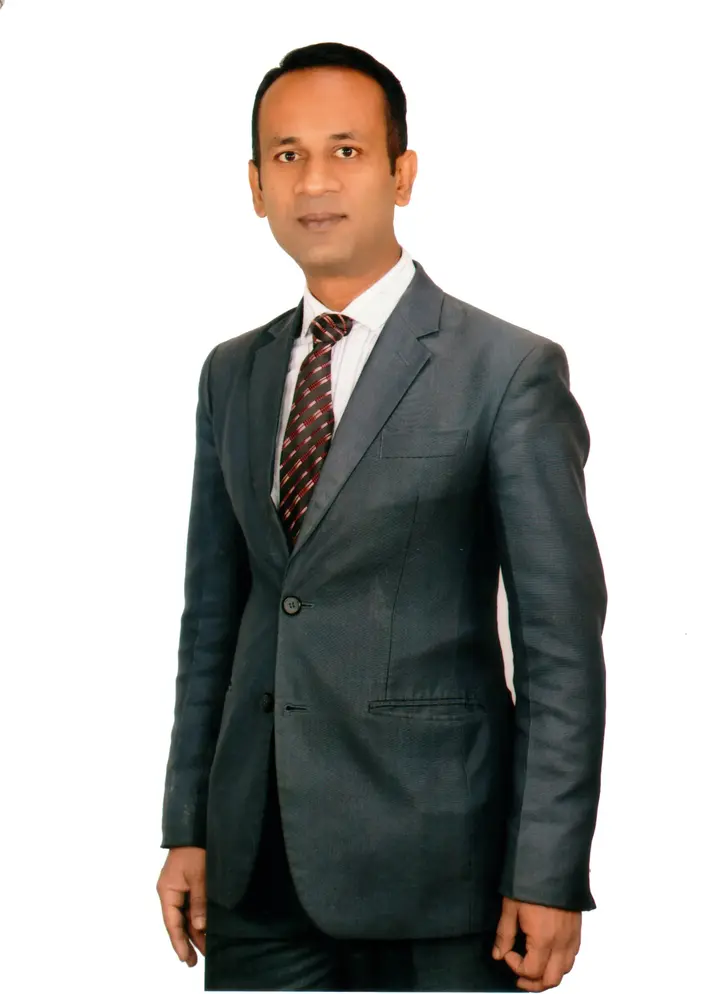 Polash Anwar wearing a dark suit and tie